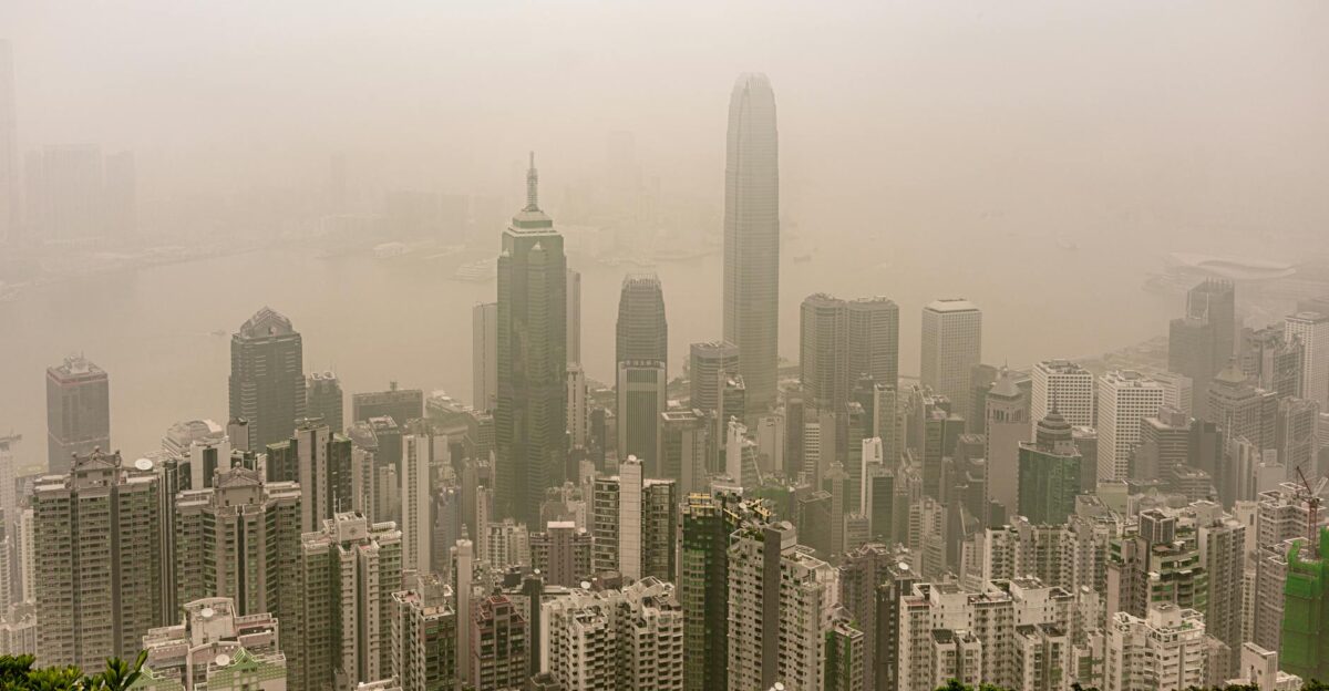 A dramatic aerial view of Hong Kong skyline enveloped in fog showcasing modern skyscrapers