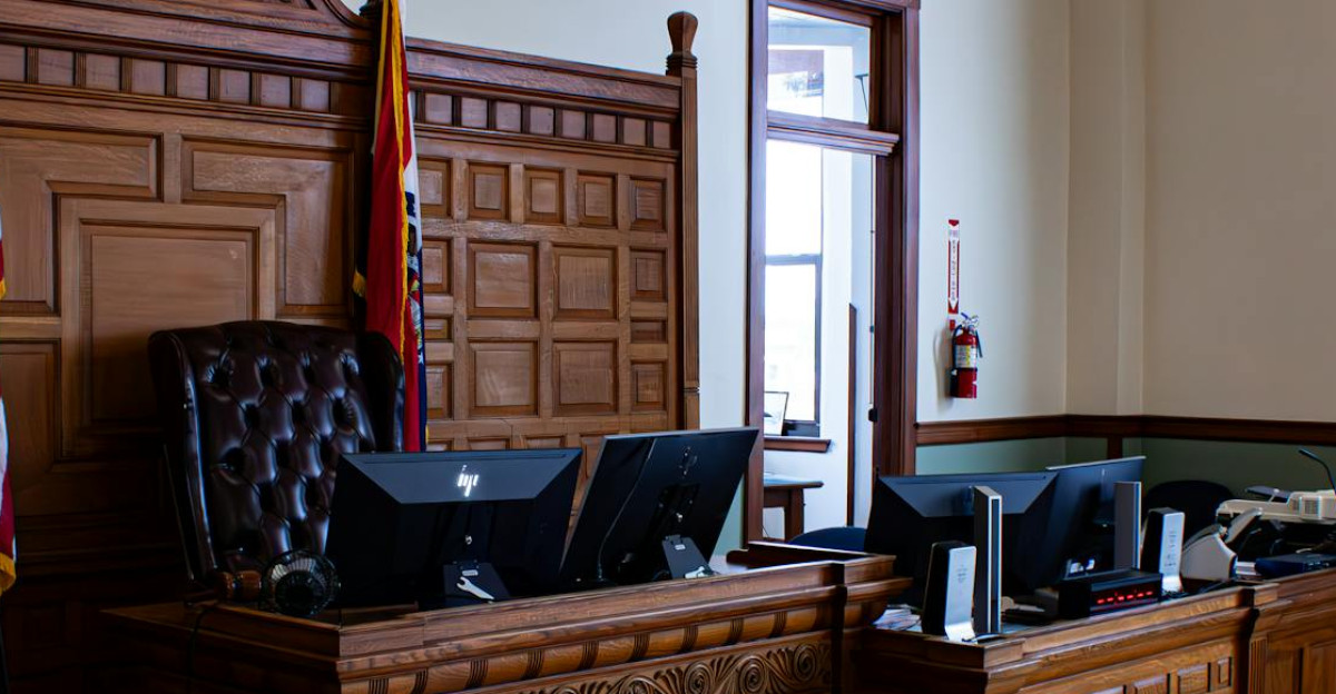 Interior view of an American courthouse in Kirksville Missouri featuring a judge s desk and flags