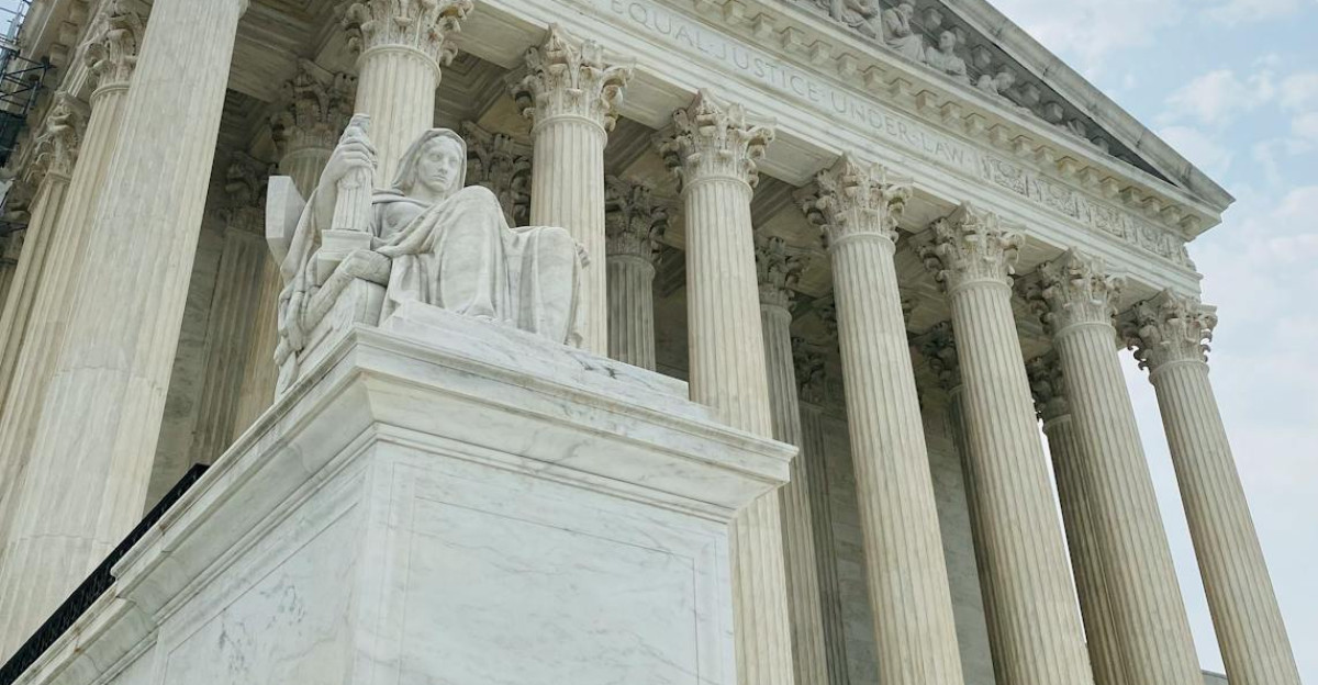 A low angle shot of the US Supreme Court showcasing its grandeur and architectural detail