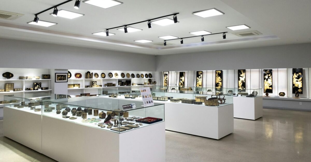 Modern museum interior with glass display cabinets showcasing artifacts