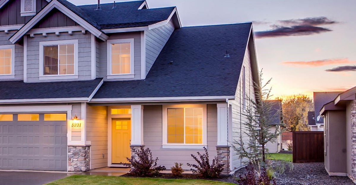 Elegant suburban home with driveway at sunset showcasing modern architecture