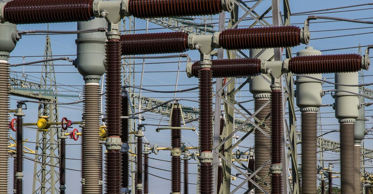 Detailed view of high voltage electrical substation with transformers and power lines