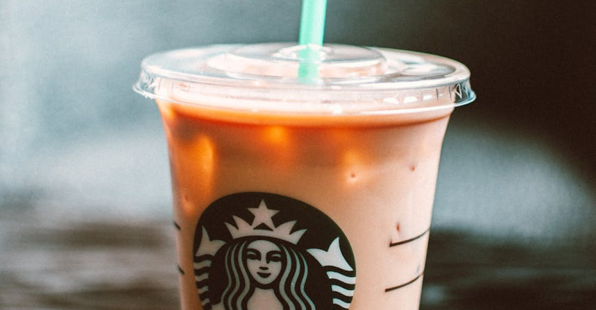 Chilled iced coffee in a Starbucks cup on a wooden table creating a refreshing vibe