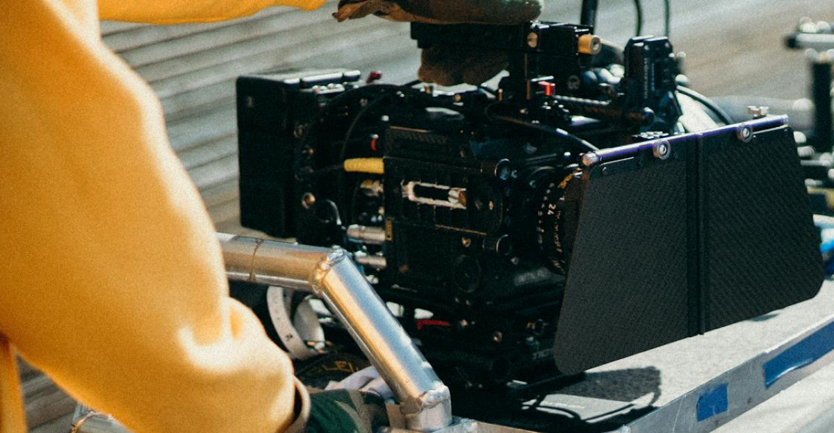 Close-up view of professional film equipment on a movie set with crew members preparing for filming