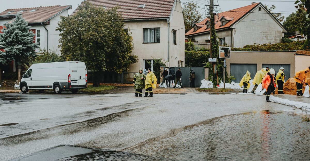 Emergency response team tackles flooding in a residential neighborhood with sandbags and preparation
