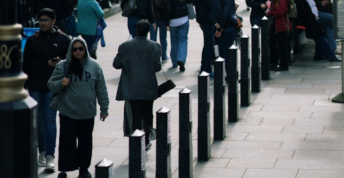 Crowded London street scene with people walking under the Union Jack
