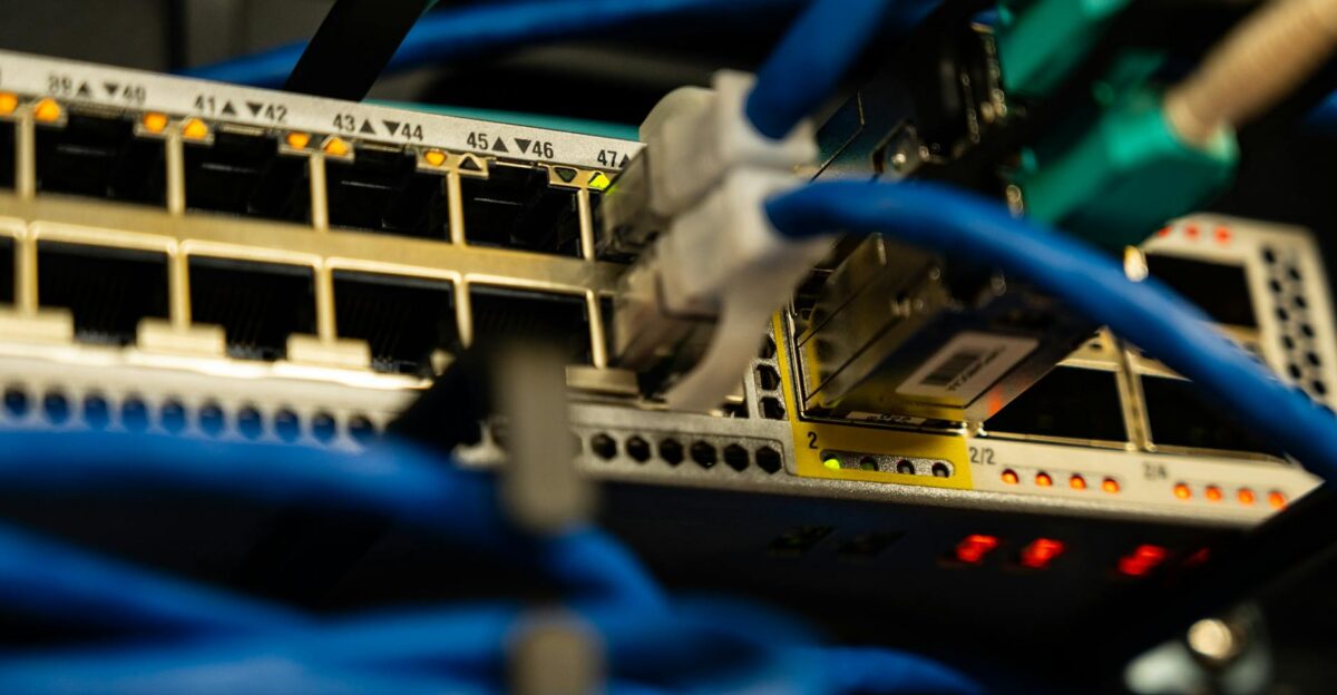 Close-up image of ethernet cables plugged into a network switch showcasing IT infrastructure