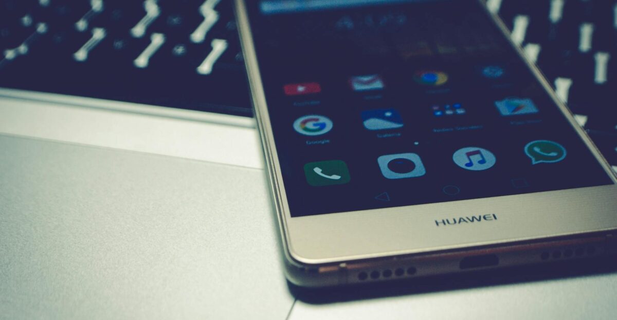 Close-up of a smartphone placed on a laptop keyboard highlighting digital interaction