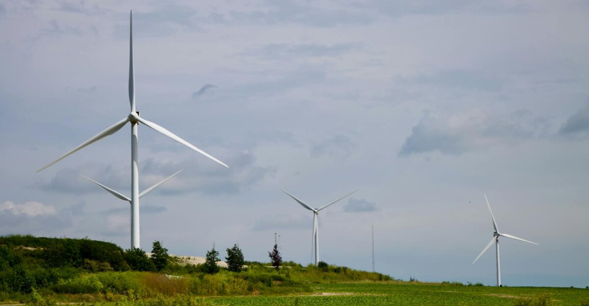 Wind turbines generating clean energy in a green field symbolizing sustainable power solutions