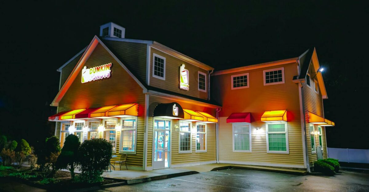 A Dunkin Donuts storefront illuminated at night in Stamford Connecticut