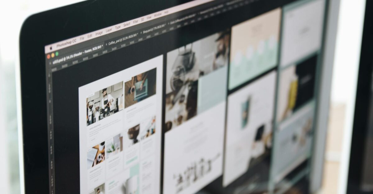 A modern computer screen displaying web design work showcasing creative visuals in a workspace
