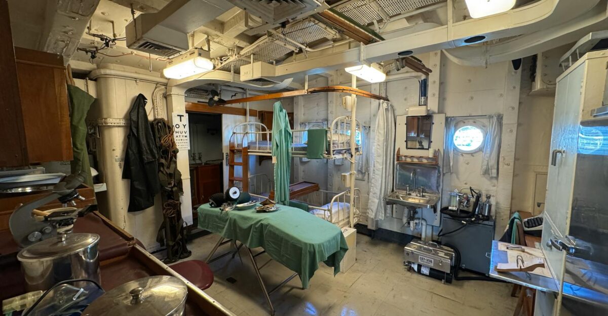 Detailed view of a vintage naval ship hospital room with medical equipment and bunk beds