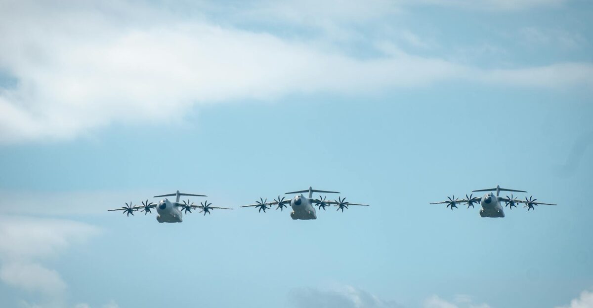 Three military aircraft flying in a clear blue sky showcasing power and precision