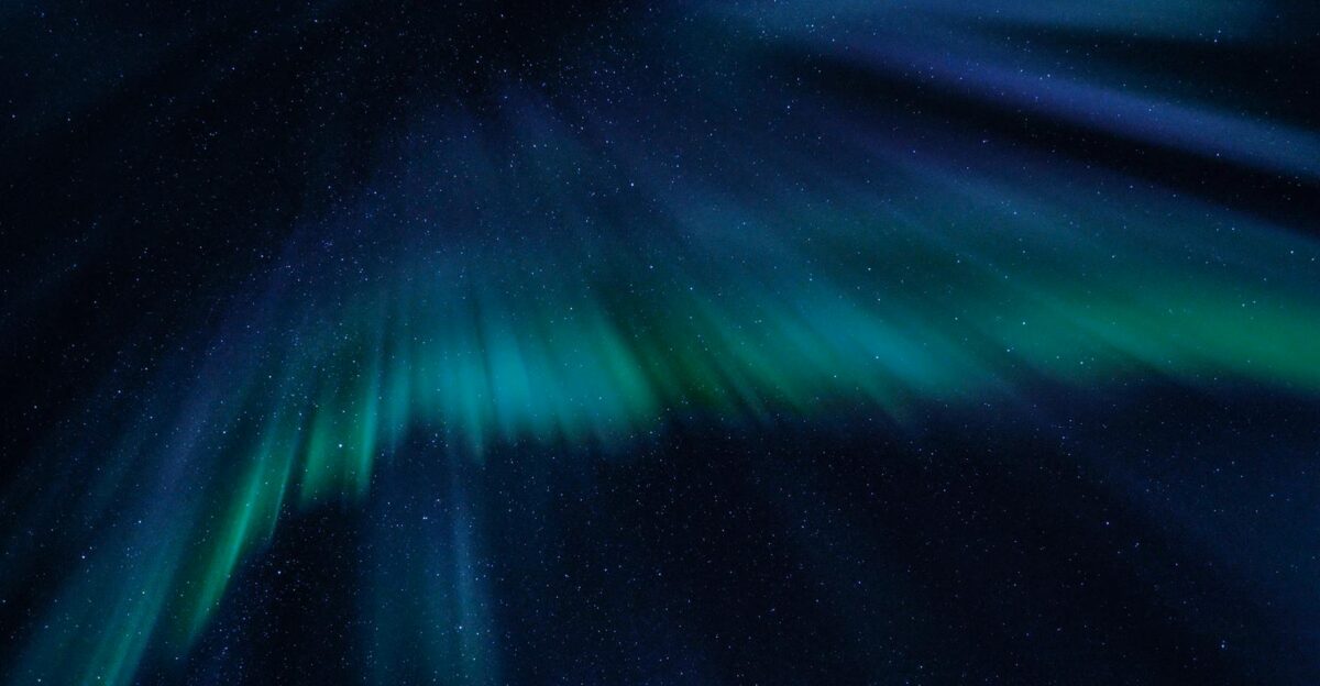 Breathtaking view of the aurora borealis illuminating the starry night sky with vibrant green and blue hues