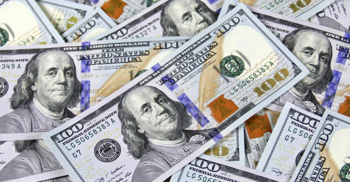 Pile of US hundred dollar bills depicting financial success and wealth.