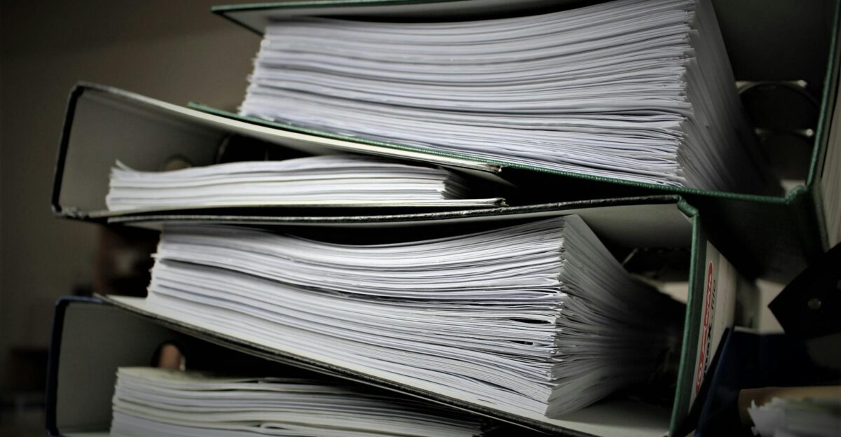 Close-up of stacked binders filled with documents for office or educational use