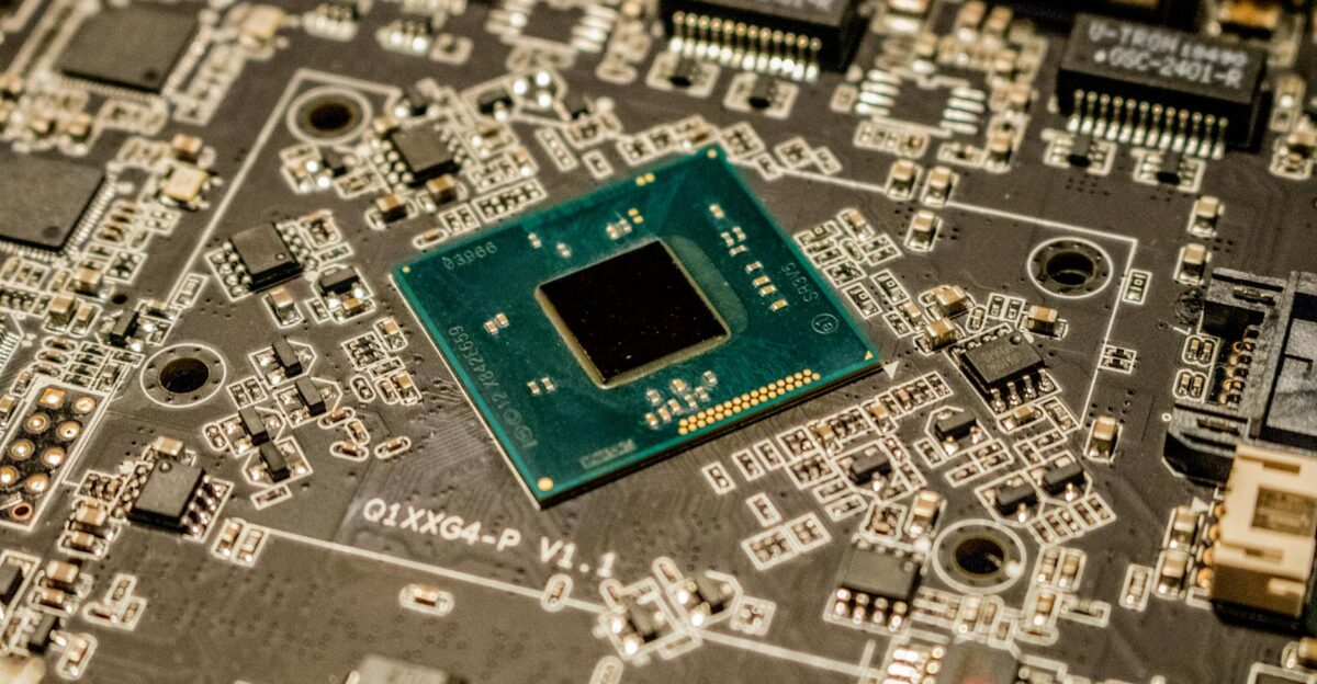 Detailed view of a microchip on a printed circuit board showcasing electronic components