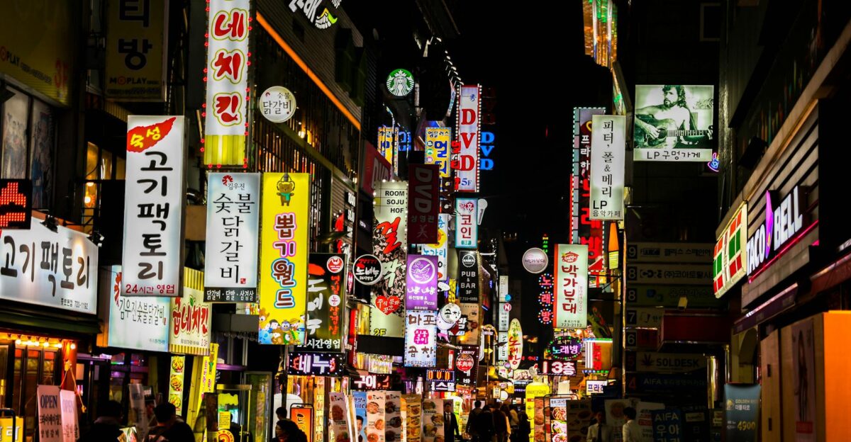 Explore Seoul s vibrant nightlife on a bustling neon-lit street lined with shops and restaurants