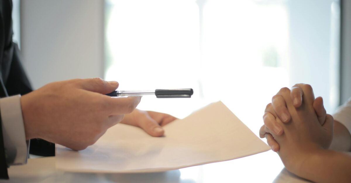 Close-up of a contract signing with hands over documents Professional business interaction