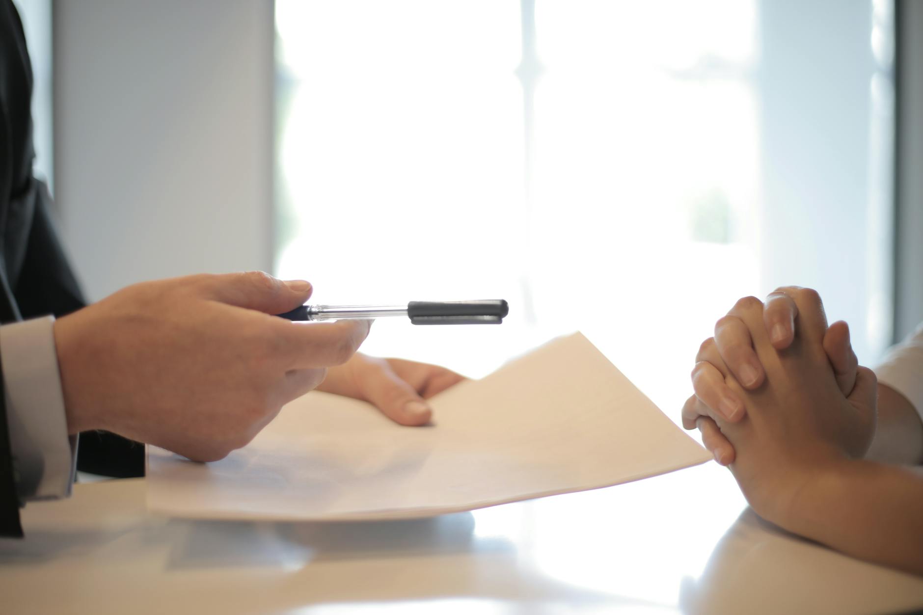 Close-up of a contract signing with hands over documents Professional business interaction