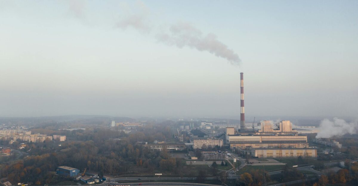 Aerial shot of a power plant emitting smoke highlighting urban air pollution and industrial impact