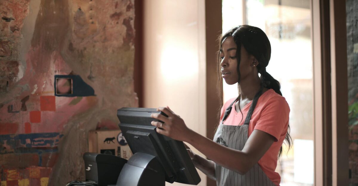 A diligent cashier processes sales in a charming store environment enhancing customer service