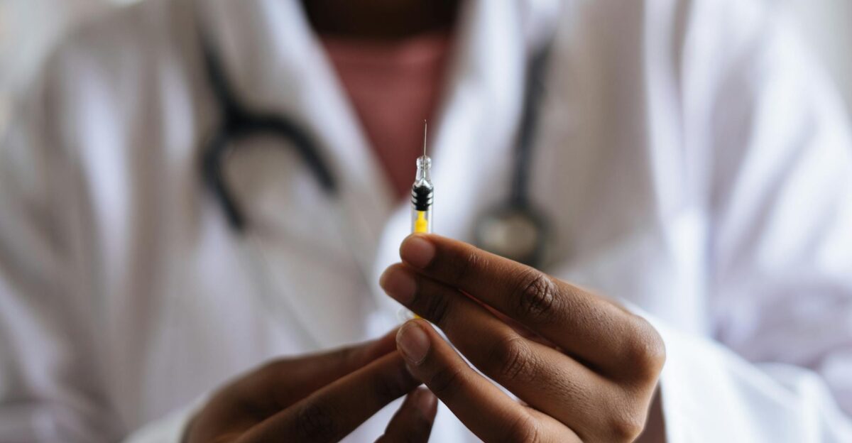 Close-up of a healthcare professional holding a syringe symbolizing medical care and vaccination