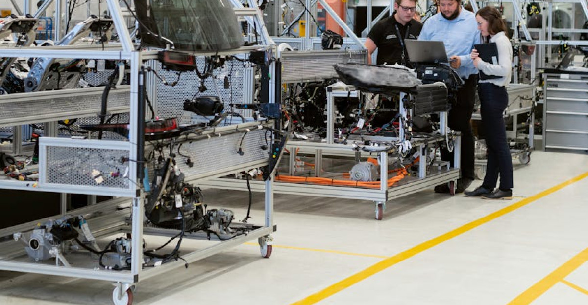Team of engineers discussing projects in a high-tech factory setting