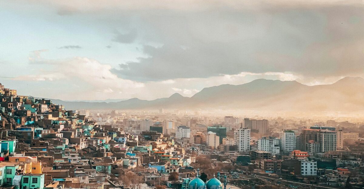 A breathtaking view of an urban cityscape at twilight with a scenic skyline and mountains