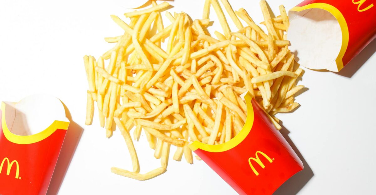 Delicious McDonald s French fries spilled on a bright white background