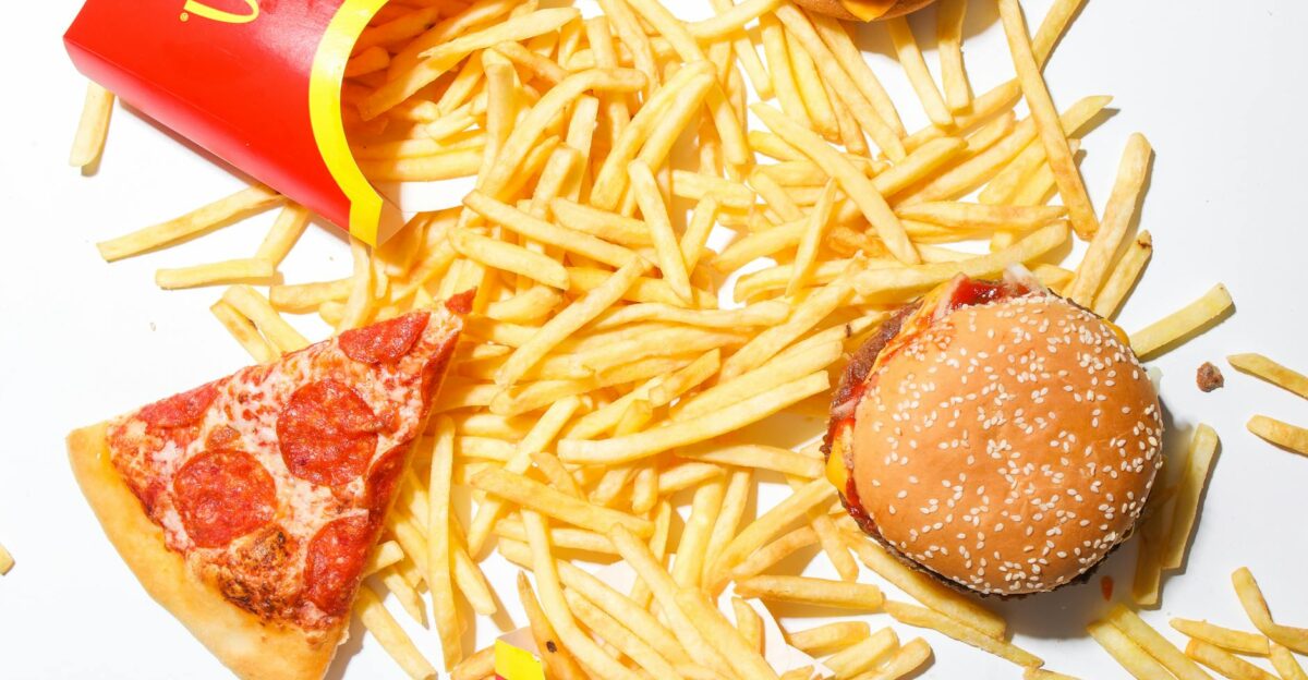A tantalizing spread of burger fries and pizza showcasing classic fast food indulgence