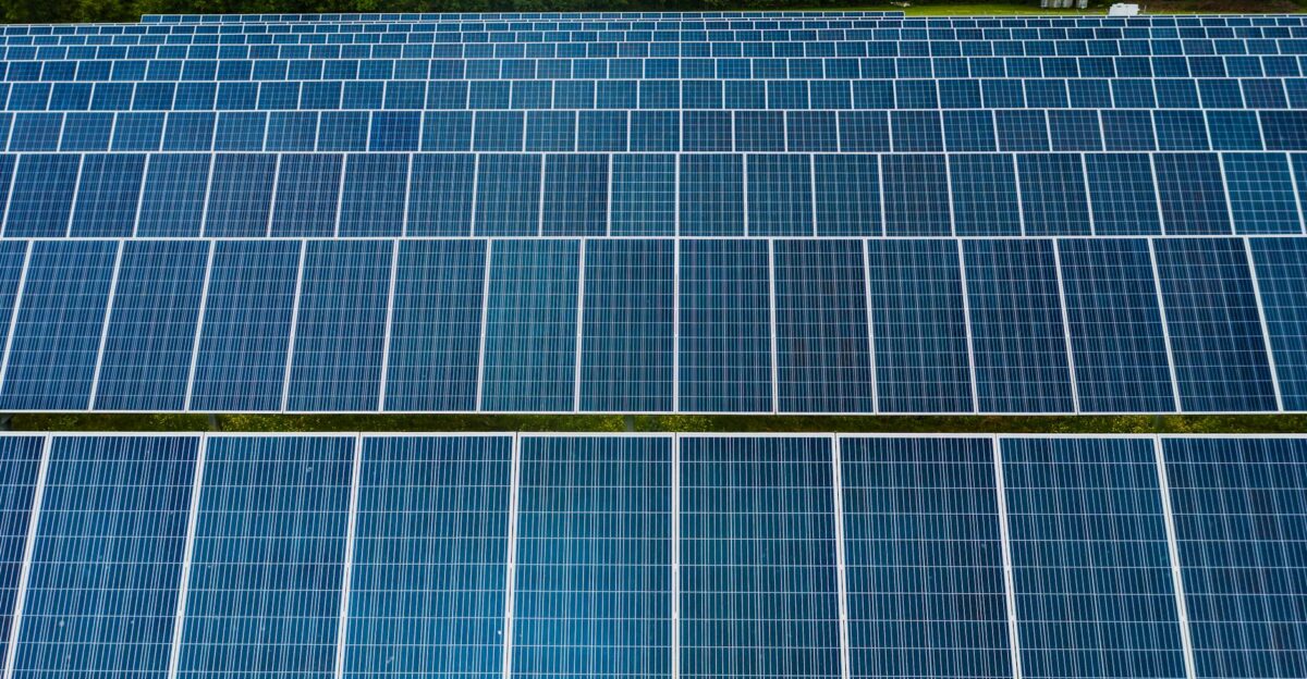 Contemporary installation of solar panels mounted on field in environmental friendly solar power station