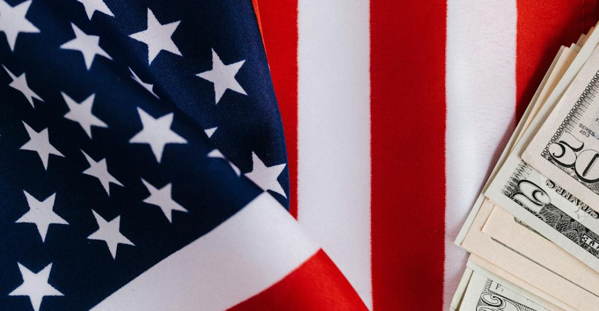 Close-up of US and China flags with US dollar bills representing international trade and finance