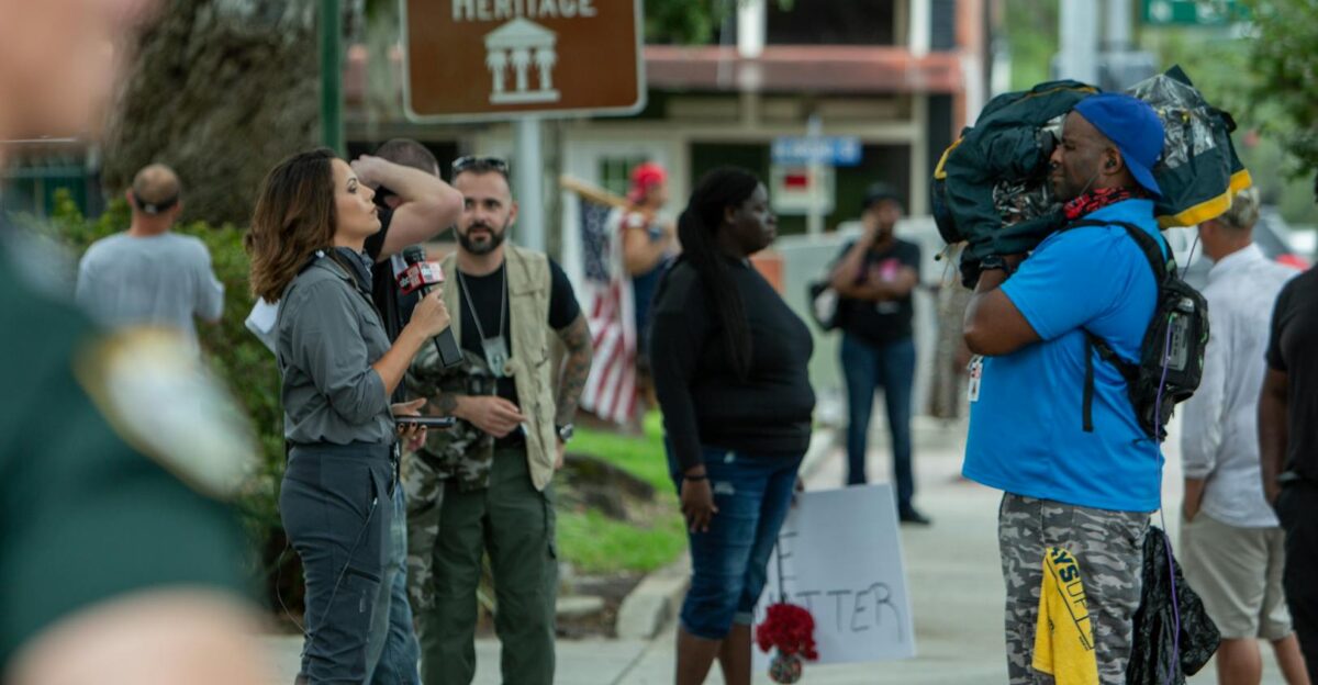 A street protest in Brooksville FL with journalists and demonstrators captured outdoors