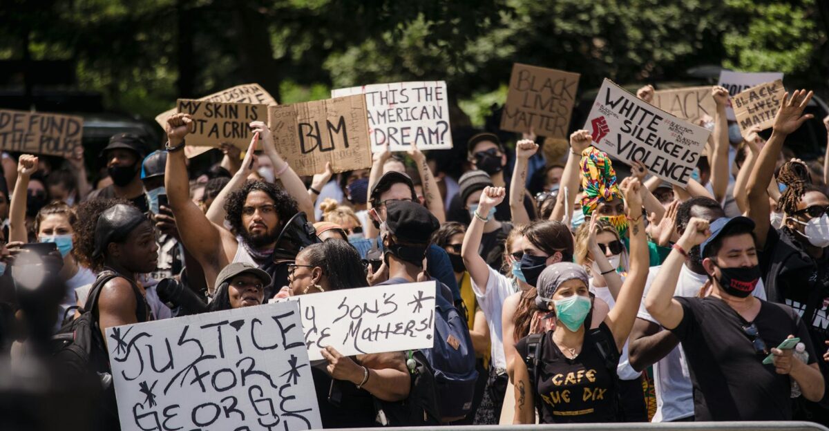 Protesters rally for justice and equality displaying powerful signs in a city street