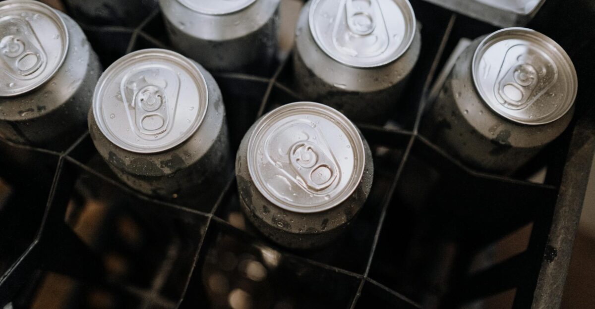 Top-down photo of aluminum beverage cans with condensation in a crate