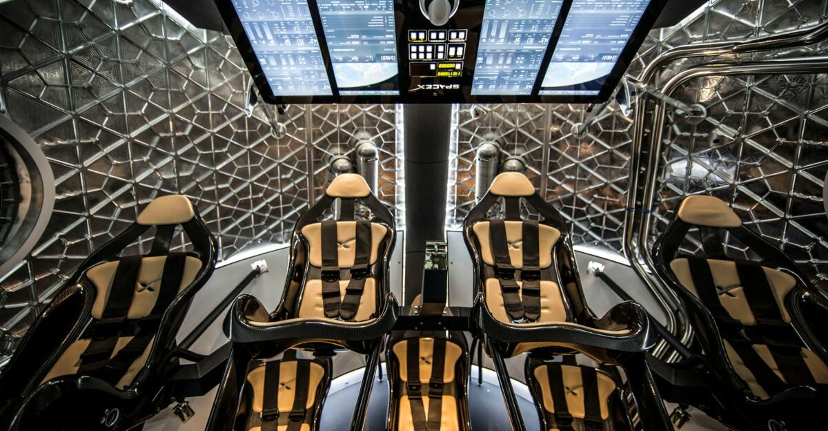 Modern spacecraft cabin showing ergonomic seats and digital control panels in a sophisticated interior