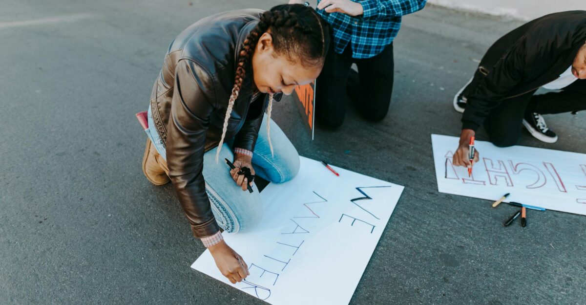 A group of young activists creates protest signs during a peaceful demonstration