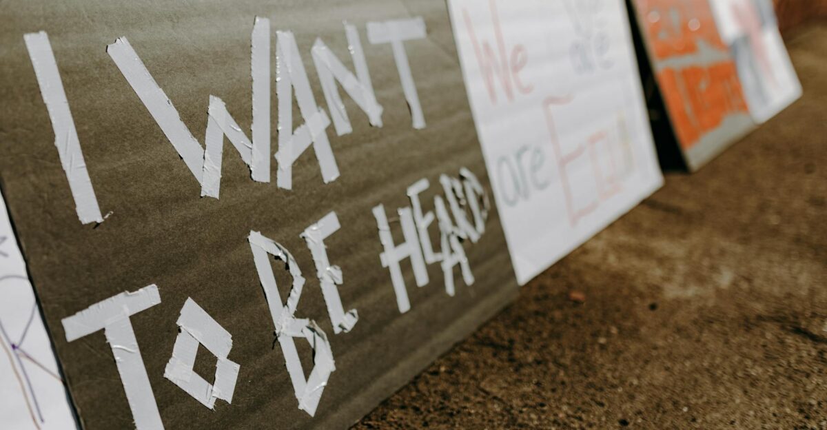 Close-up of protest signs calling for equality and justice placed on the ground
