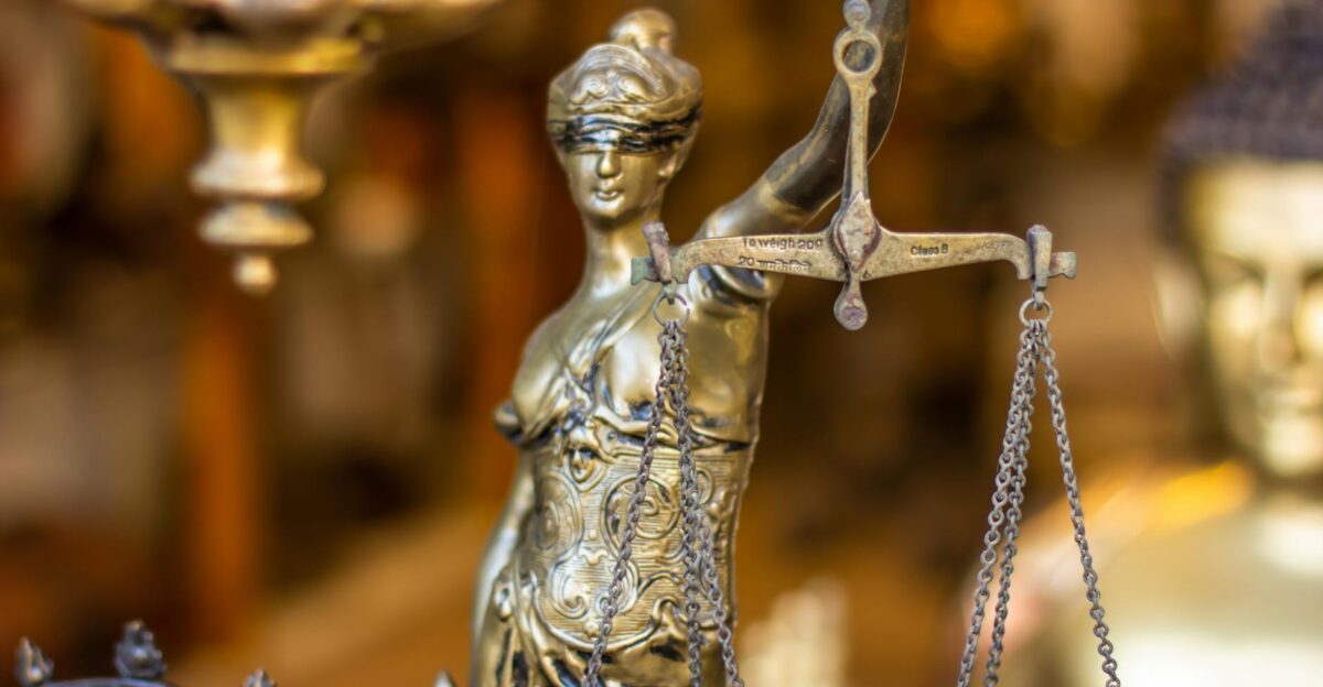 A detailed close-up of a Lady Justice statue holding scales symbolizing law and justice