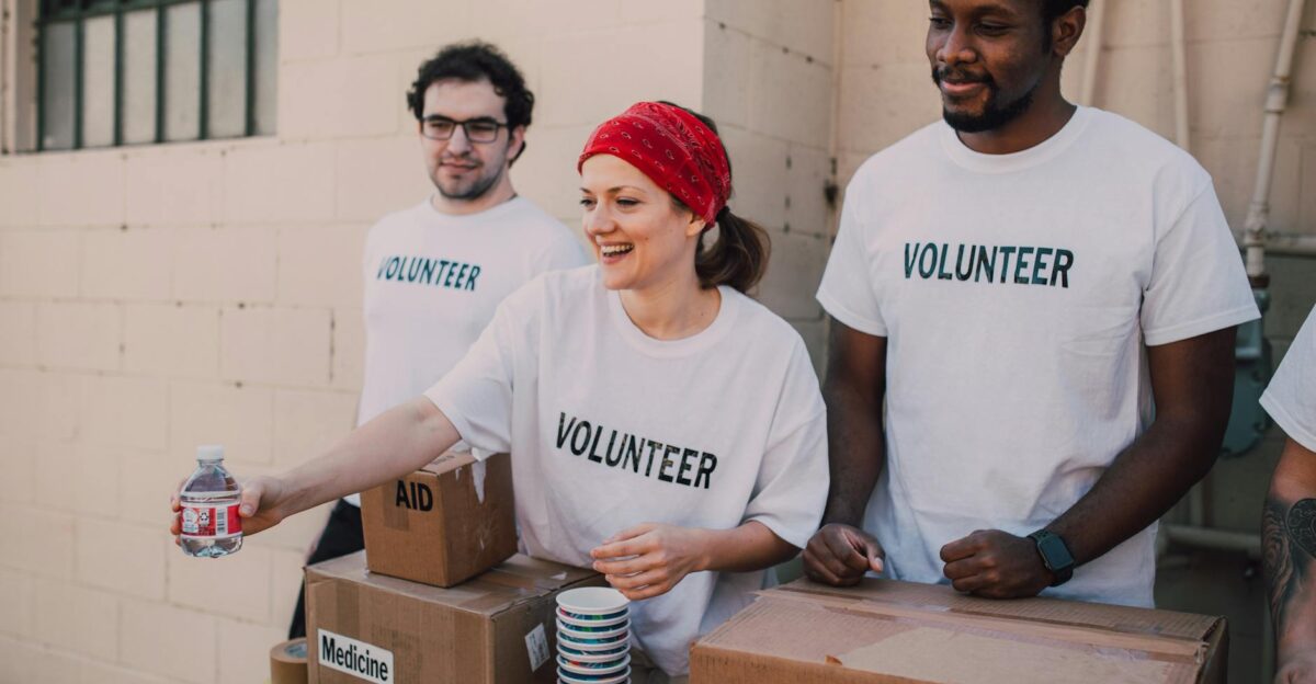 Volunteers distributing aid at an outdoor donation center promoting social impact and diversity