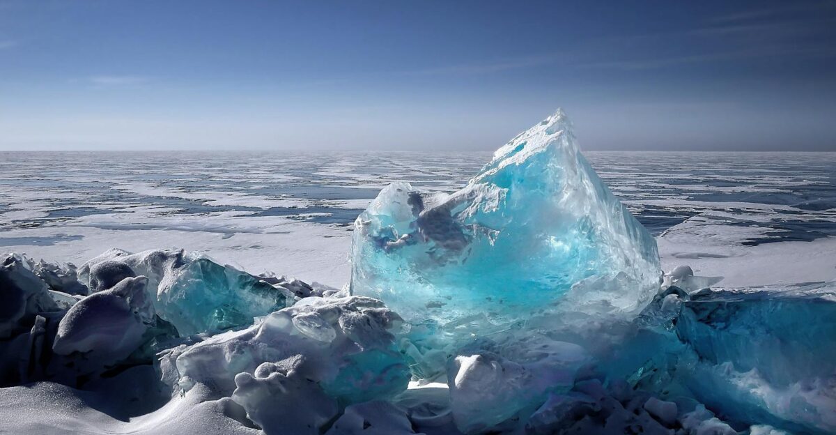 Captivating ice formation on a frozen lake under a bright blue sky during winter