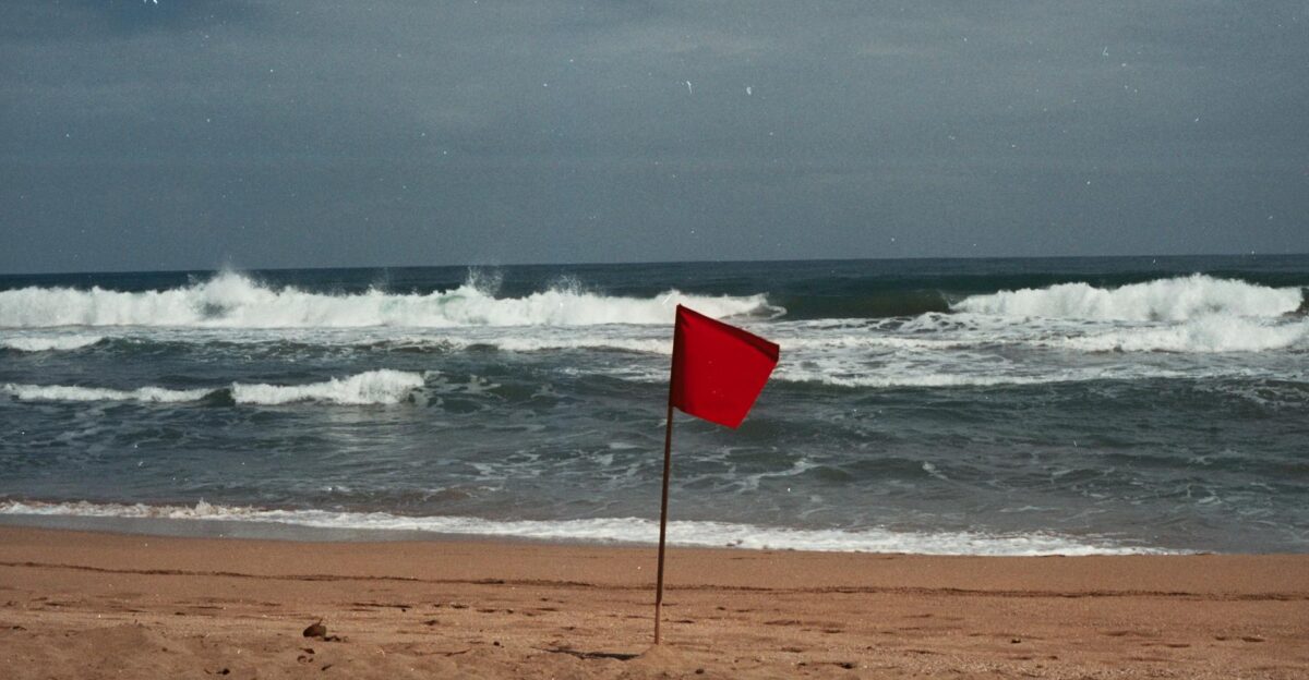 A red flag signals dangerous conditions on a Costa Rican beach Stay cautious