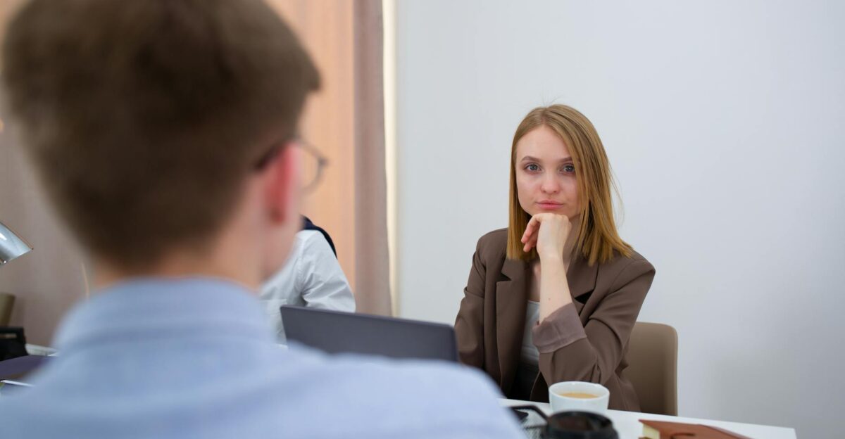 Businesswoman attentively listens during an office meeting Engaged in discussion