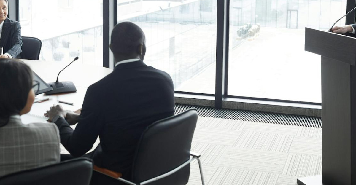 Corporate professionals engaged in a formal business meeting in a modern conference room setting
