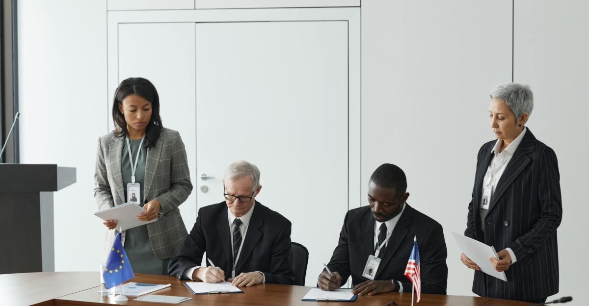 Business leaders signing a significant agreement in a conference room setting
