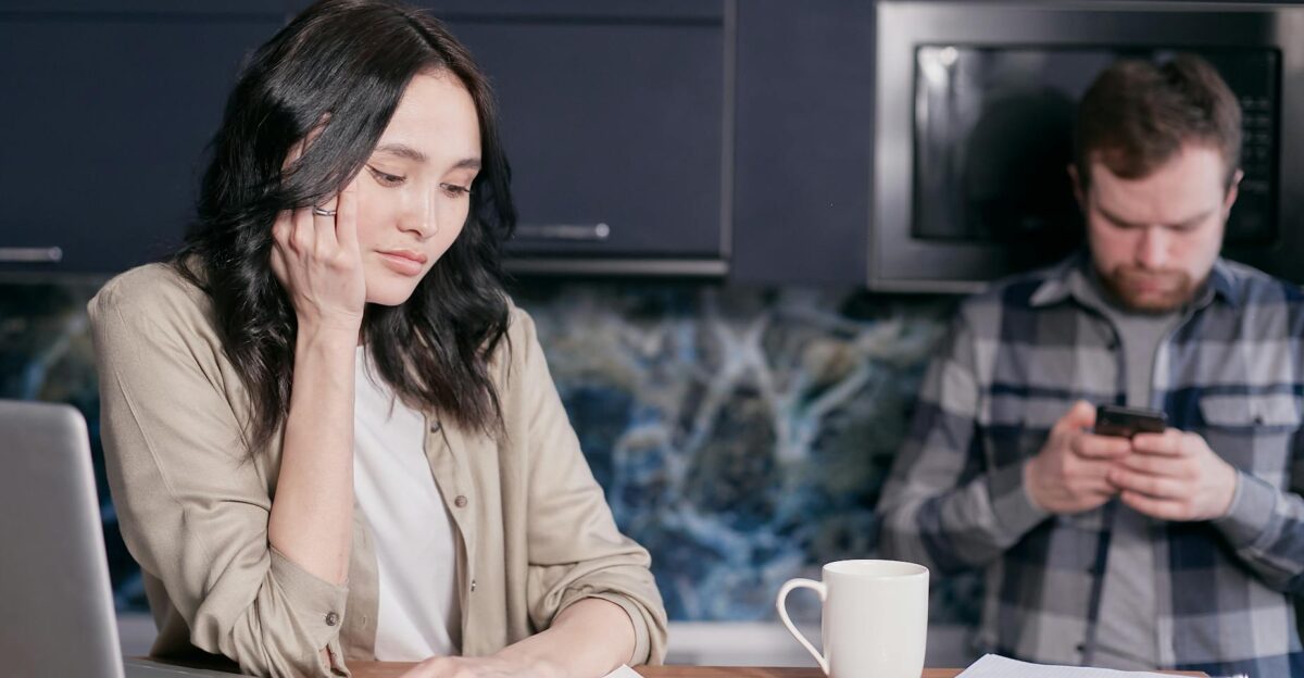 Couple experiencing stress while managing household finances at home