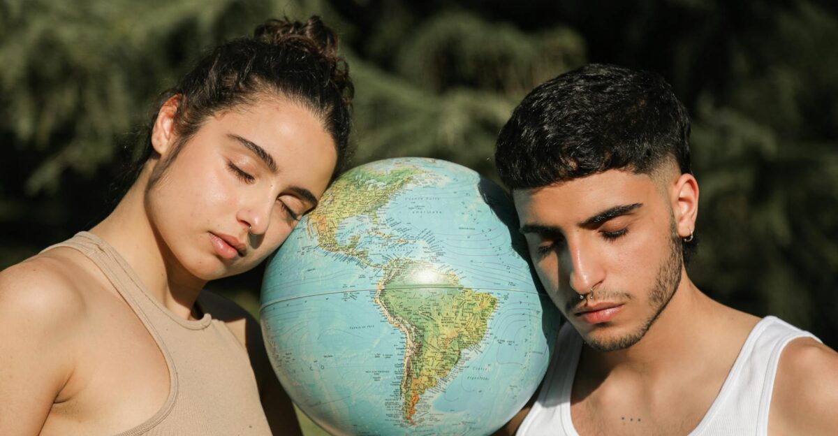 Two people with closed eyes embracing a globe representing environmental consciousness