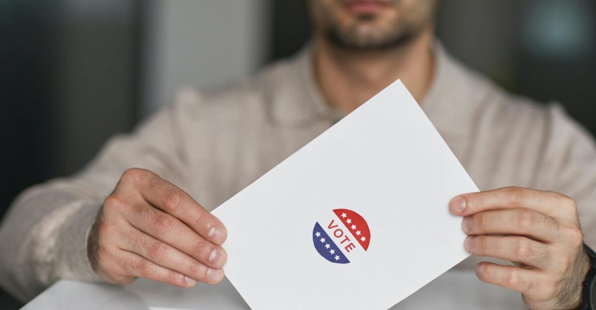 A man holds a voting envelope with a vote sticker Symbolizes election participation