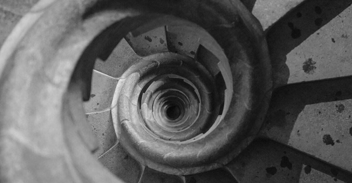Top view of a spiral staircase in a historic Barcelona building showcasing geometric patterns